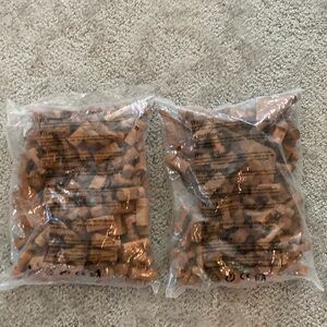 Two sealed bags of Lincoln logs pieces.